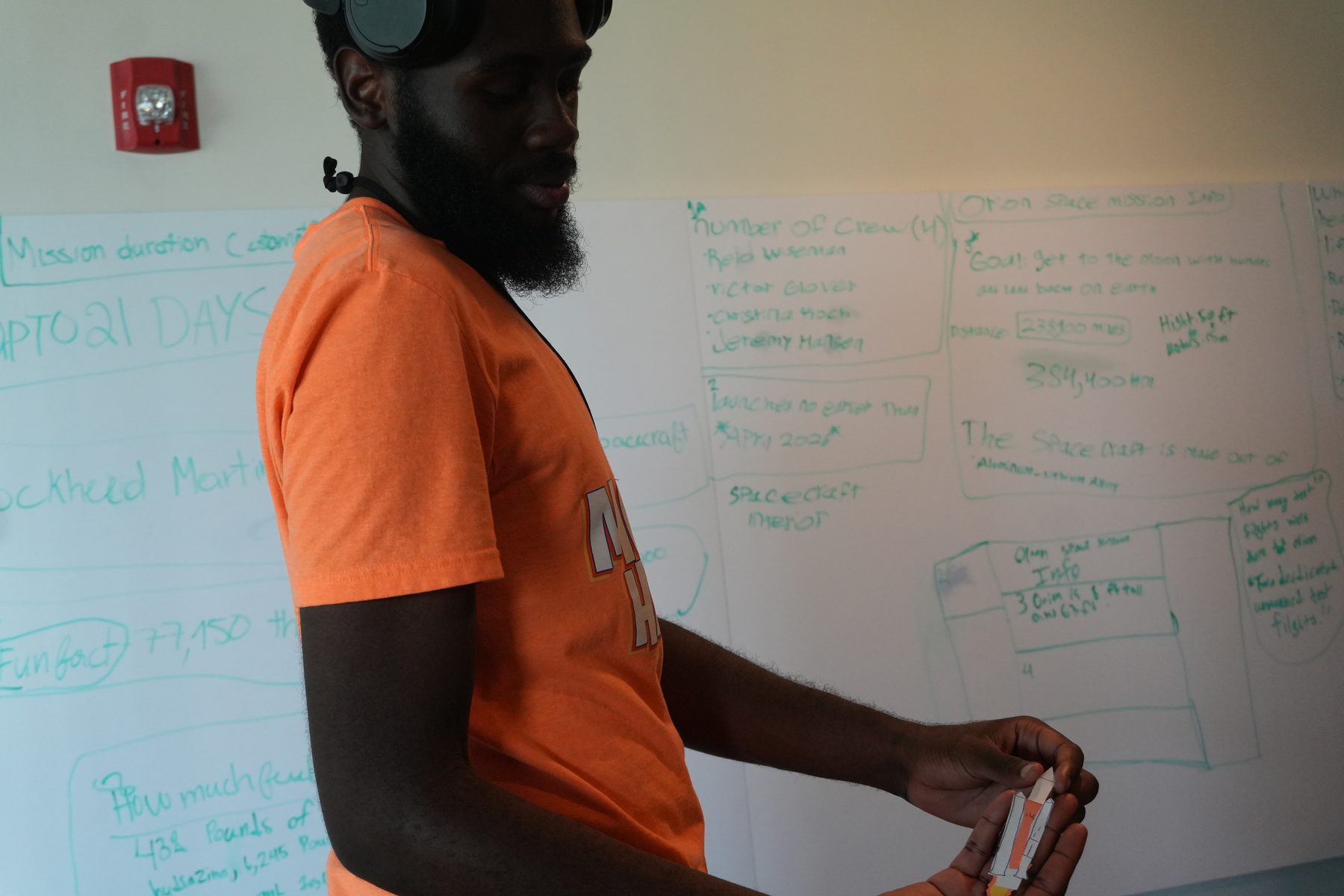 Daniel Onyejiekwe teaching a lesson on a whiteboard during a CodeBears session