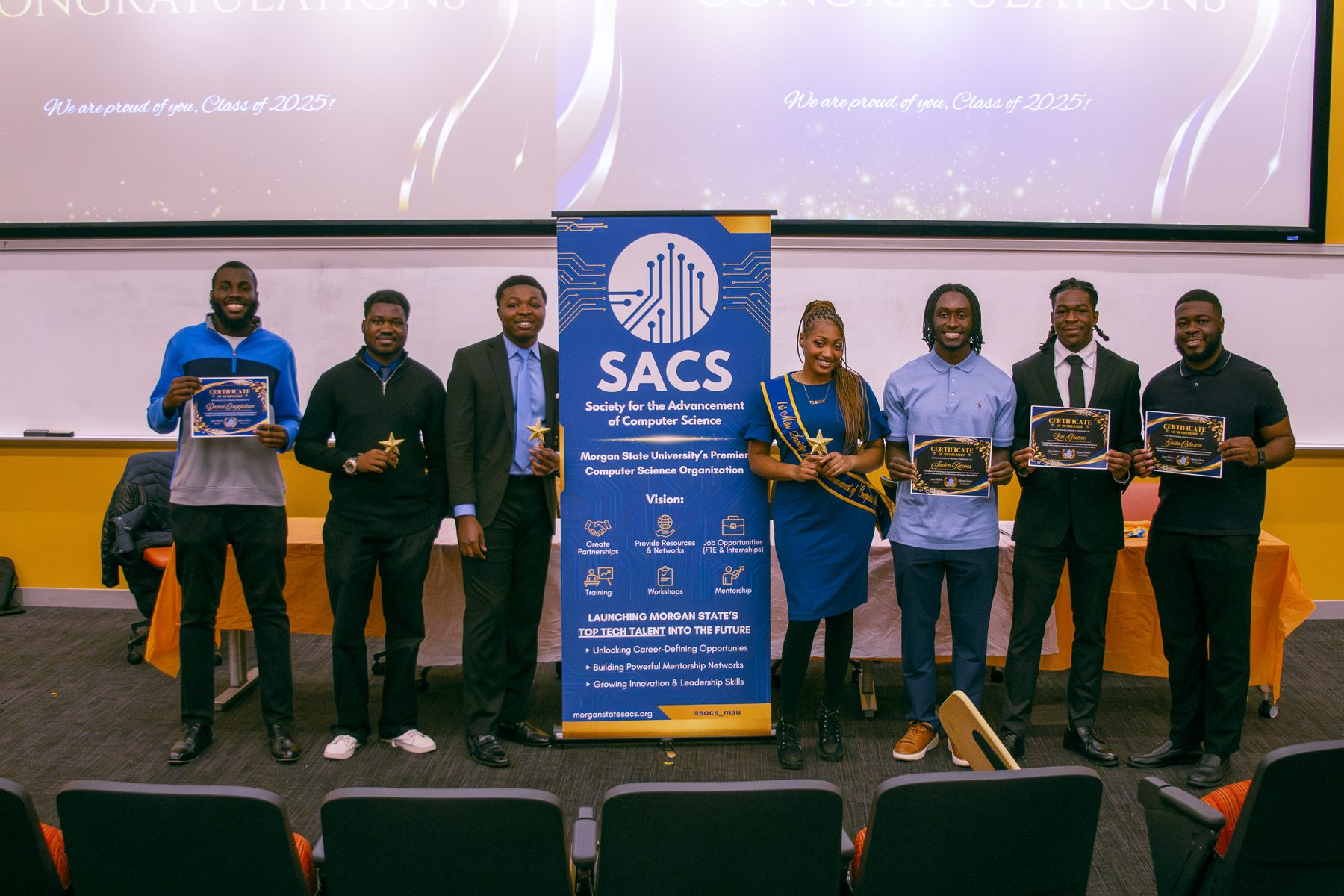 Daniel Onyejiekwe with the newly inducted SACS class holding certificates